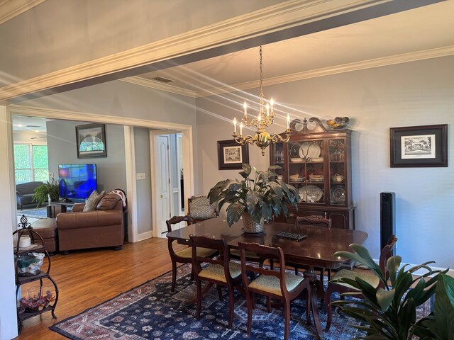 2451 Lake Douglas Rd, Bainbridge, GA 39819 - dining space featuring visible vents, wood finished floors, an inviting chandelier, and crown molding
