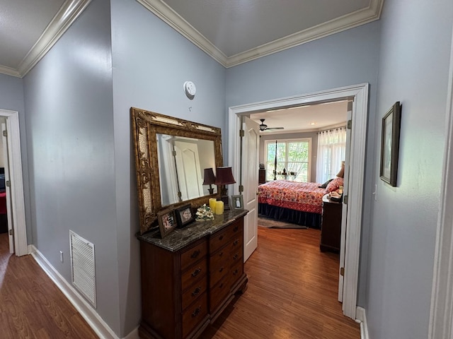 2451 Lake Douglas Rd, Bainbridge, GA 39819 - corridor with visible vents, crown molding, baseboards, and dark wood-style flooring