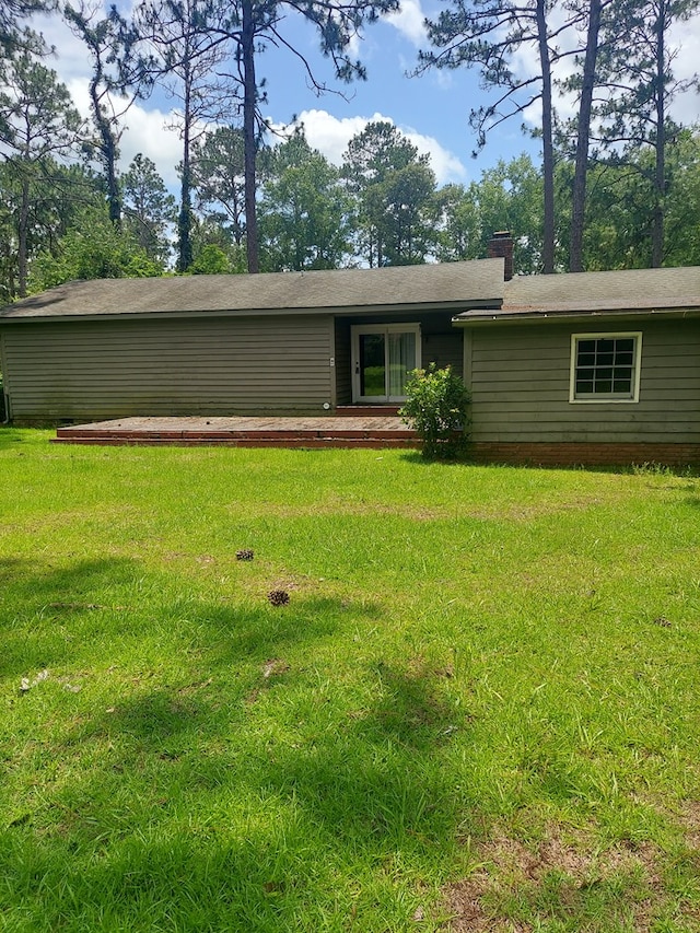 rear view of property with a yard and a patio