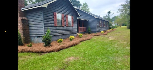 view of property exterior with a chimney and a yard