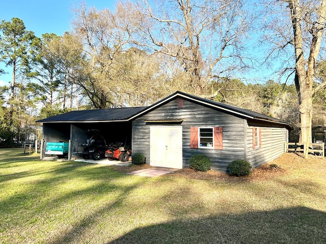 view of outdoor structure with an attached carport and an outdoor structure