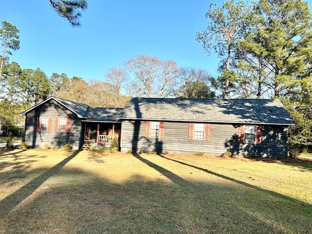 view of front of home featuring covered porch and a front yard