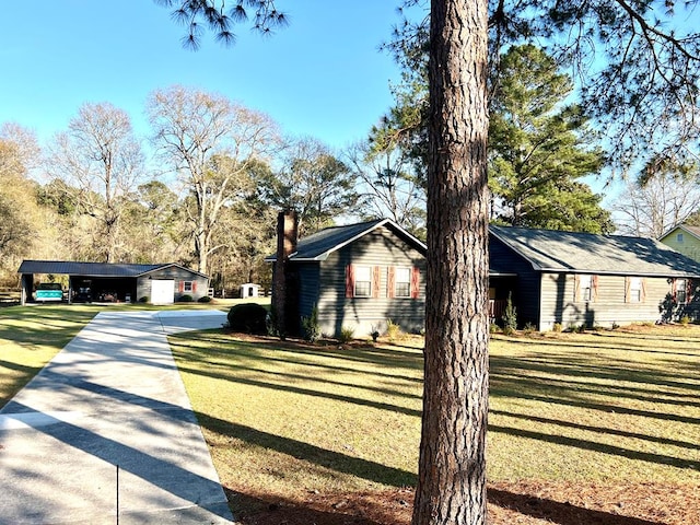 view of side of property with a yard and driveway