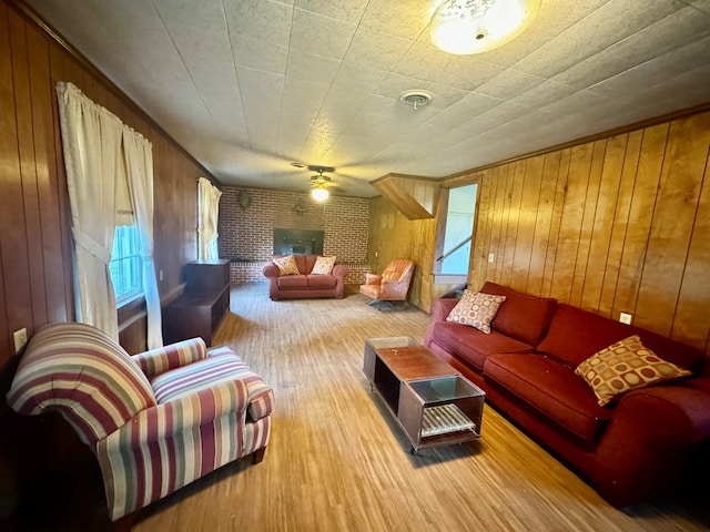 living room featuring wooden walls, a fireplace, and wood-type flooring