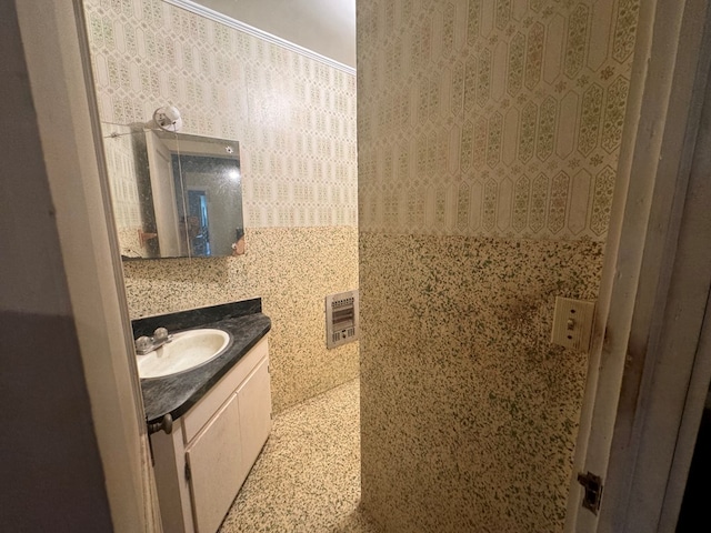 bathroom with heating unit, vanity, and tile walls