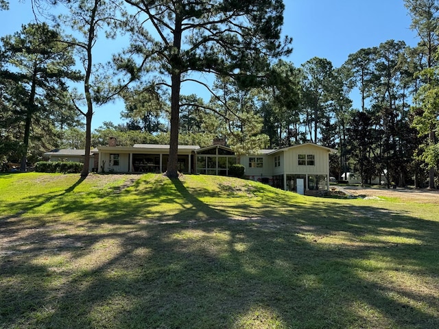 view of yard featuring a sunroom