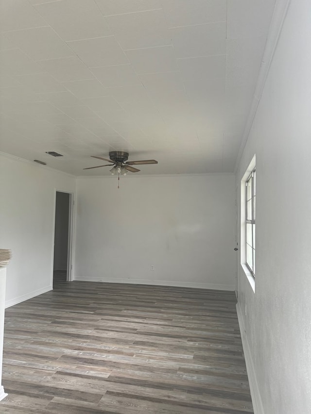 unfurnished room featuring ceiling fan, wood-type flooring, and crown molding