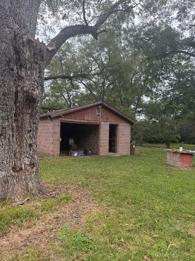 view of outbuilding featuring a yard