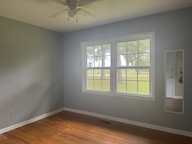 spare room with hardwood / wood-style floors and ceiling fan