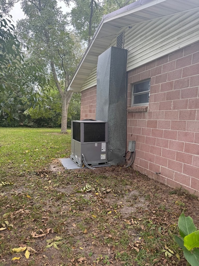 view of side of home with a lawn