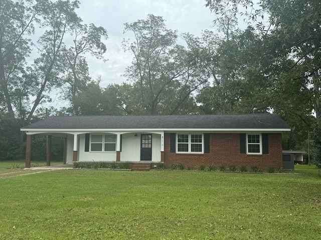 single story home with a front yard and a carport