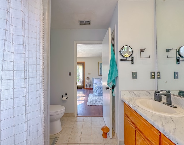 bathroom with ensuite bathroom, visible vents, toilet, tile patterned floors, and vanity