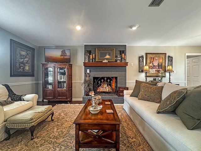 living room featuring a brick fireplace