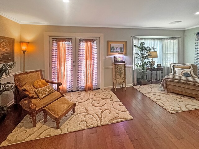 sitting room featuring crown molding, hardwood / wood-style flooring, and french doors
