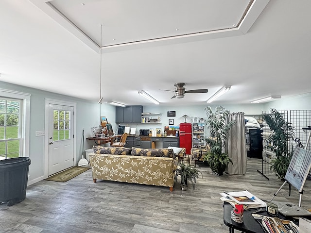living room featuring hardwood / wood-style flooring and ceiling fan