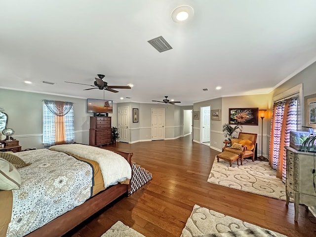 bedroom with ornamental molding and dark wood-type flooring