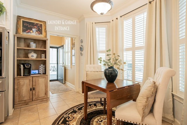 interior space featuring crown molding, baseboards, and light tile patterned floors