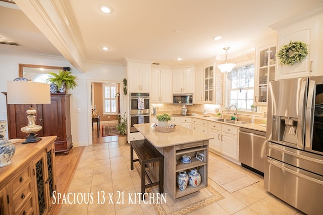 kitchen with pendant lighting, open shelves, appliances with stainless steel finishes, white cabinets, and a sink