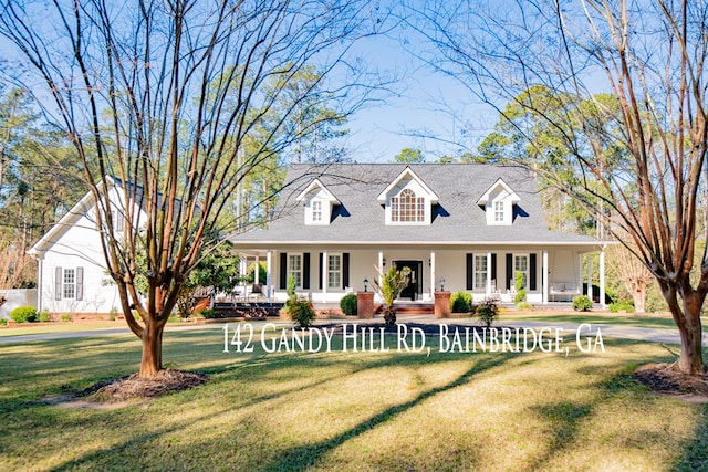 new england style home featuring a front yard