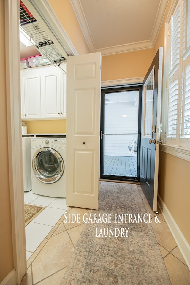 washroom with light tile patterned floors, baseboards, cabinet space, washer / clothes dryer, and crown molding