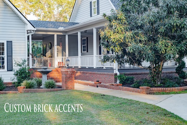 property entrance featuring a porch, roof with shingles, and a lawn