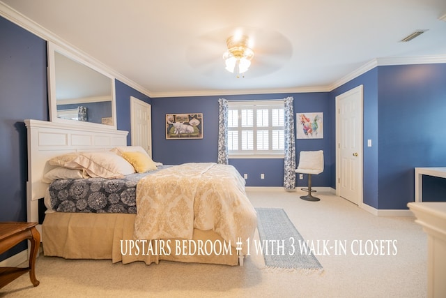 bedroom with carpet floors, ornamental molding, visible vents, and baseboards