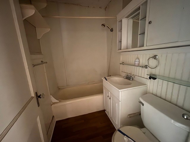 full bathroom featuring shower / washtub combination, hardwood / wood-style floors, vanity, and toilet