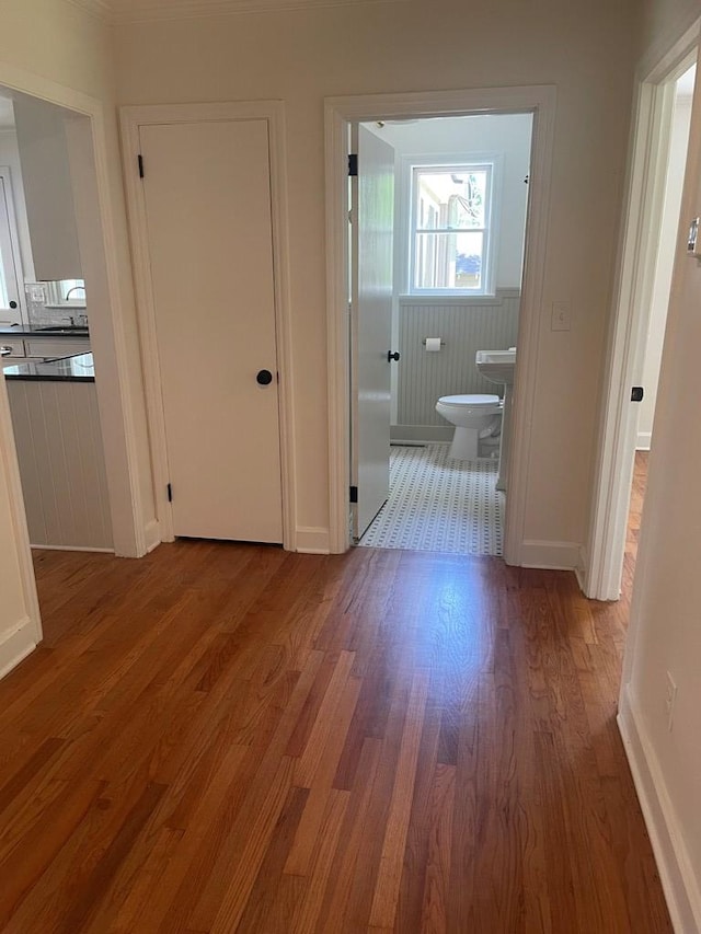1202 Tallahassee Hwy, Bainbridge, GA 39819 - corridor with wood finished floors, baseboards, and a sink