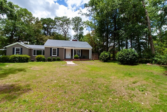 1202 Tallahassee Hwy, Bainbridge, GA 39819 - view of front of house featuring a porch, a front yard, and a chimney
