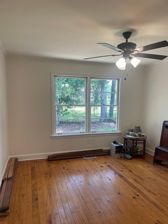 1202 Tallahassee Hwy, Bainbridge, GA 39819 - unfurnished room featuring healthy amount of natural light, wood-type flooring, ornamental molding, ceiling fan, and baseboards