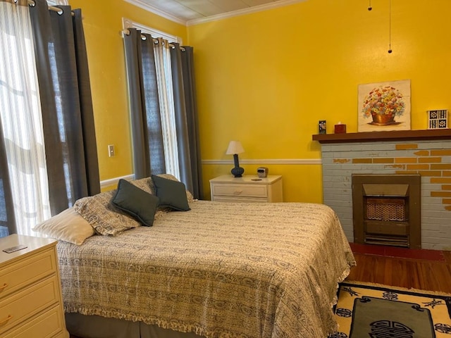 40 SW 5th Ave, Cairo, GA 39828 - bedroom featuring crown molding, a fireplace, and wood finished floors