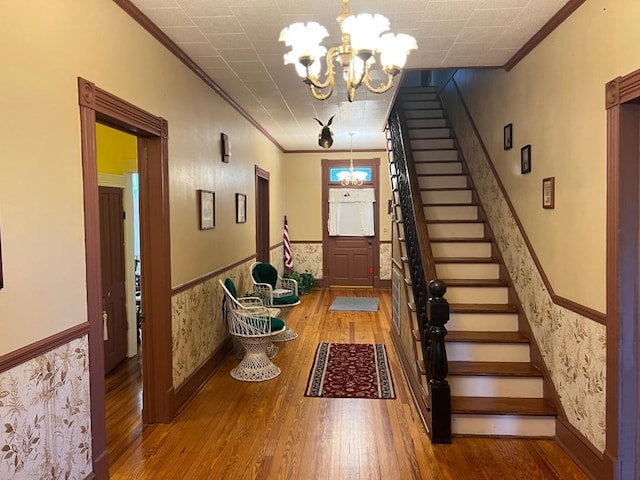 40 SW 5th Ave, Cairo, GA 39828 - entrance foyer with a chandelier, crown molding, wood finished floors, stairway, and a wainscoted wall