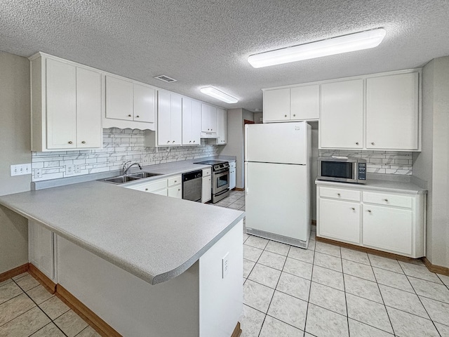 kitchen featuring white cabinets, stainless steel appliances, and sink