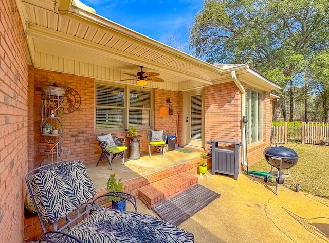 view of patio featuring ceiling fan, fence, and grilling area