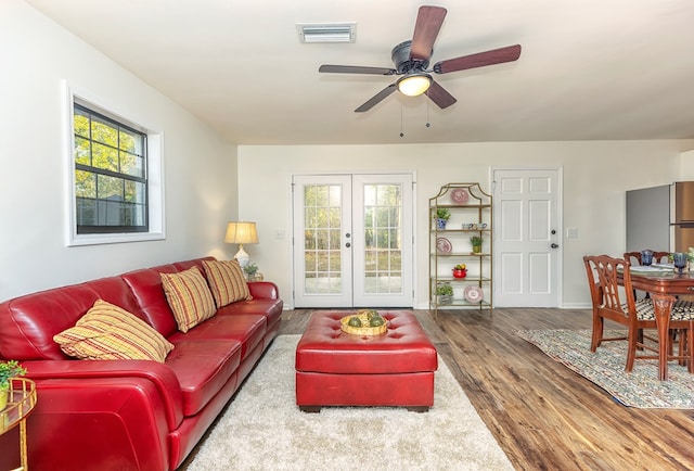 living room with hardwood / wood-style flooring, ceiling fan, and french doors