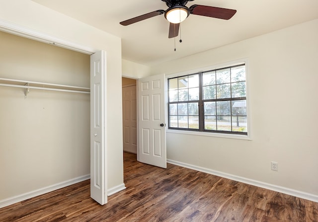 unfurnished bedroom with a closet, ceiling fan, and dark hardwood / wood-style flooring