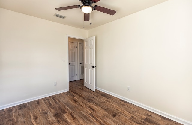 unfurnished room with dark hardwood / wood-style floors and ceiling fan