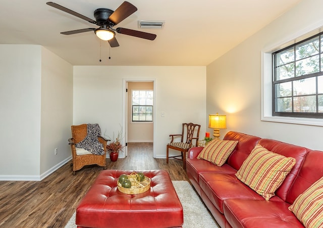 living room featuring ceiling fan, plenty of natural light, and dark hardwood / wood-style floors