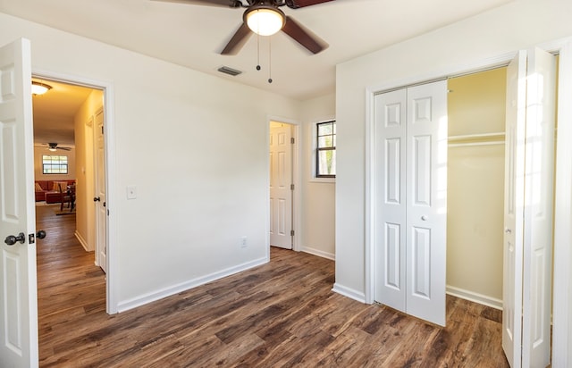 unfurnished bedroom featuring ceiling fan and dark hardwood / wood-style floors