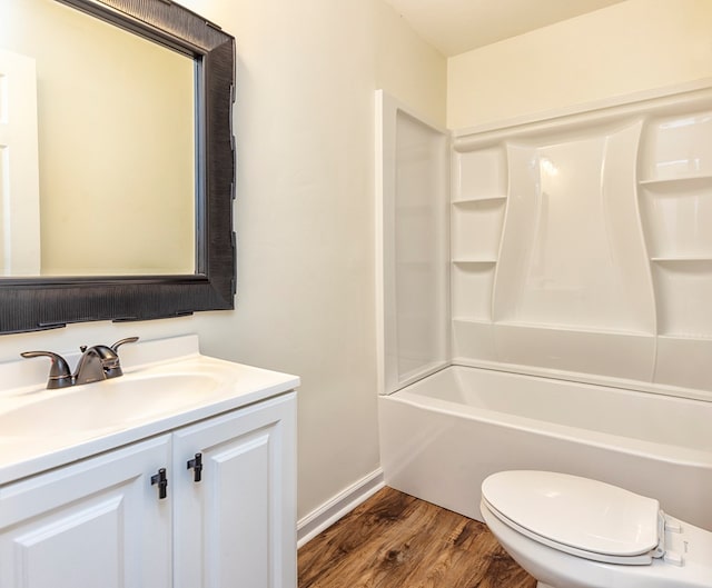 full bathroom featuring hardwood / wood-style floors, vanity, toilet, and shower / tub combination