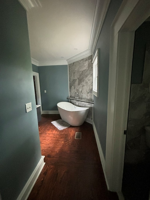 bathroom featuring crown molding, a bath, and wood-type flooring