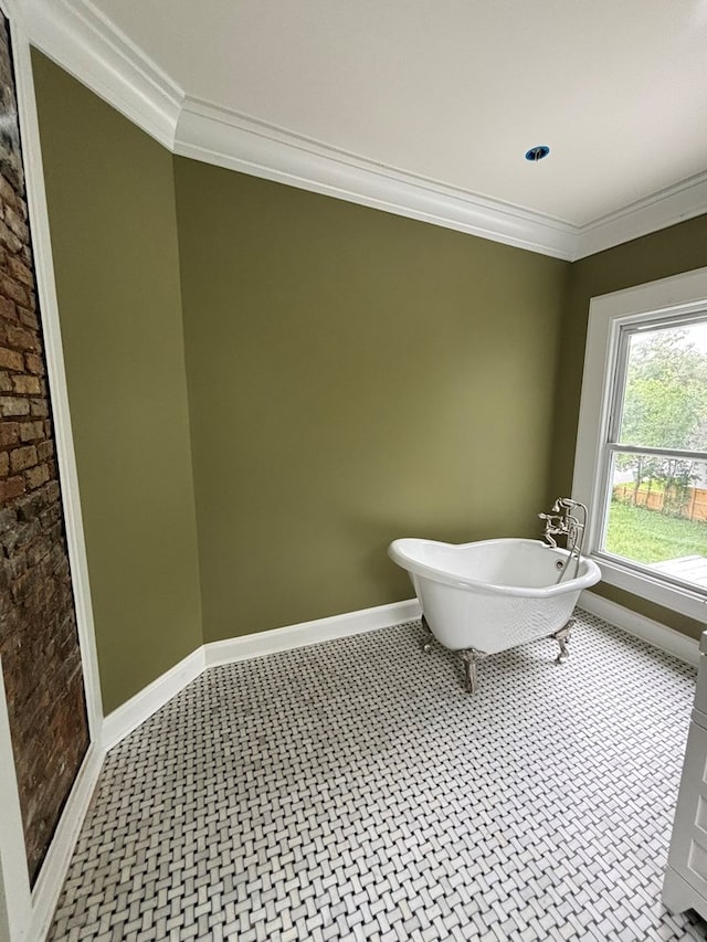 bathroom with crown molding and a bathtub