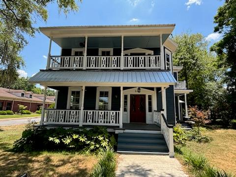 view of front of property with a balcony and a porch