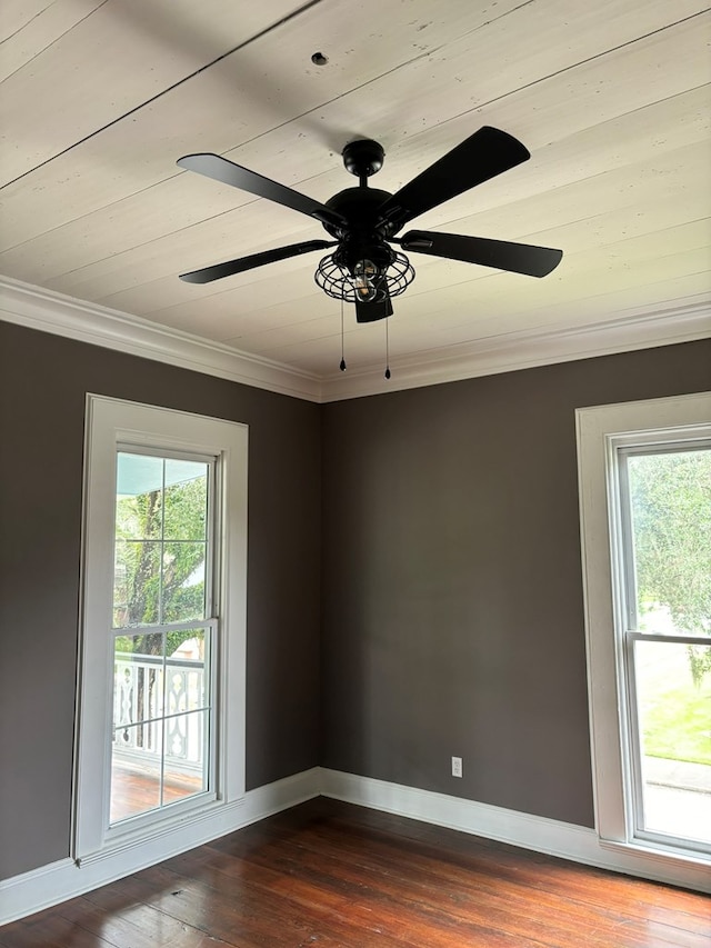 empty room with ceiling fan, hardwood / wood-style floors, and ornamental molding