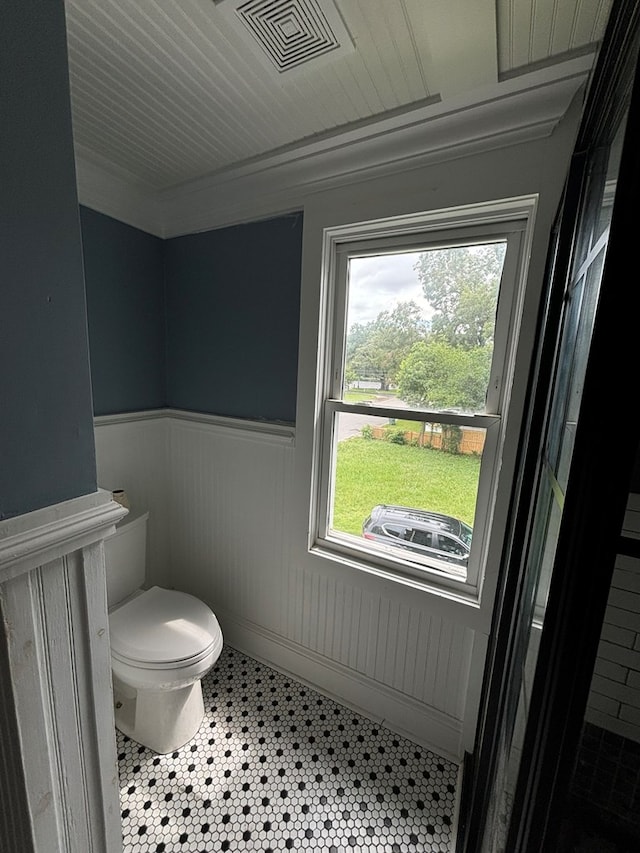 bathroom featuring toilet and crown molding