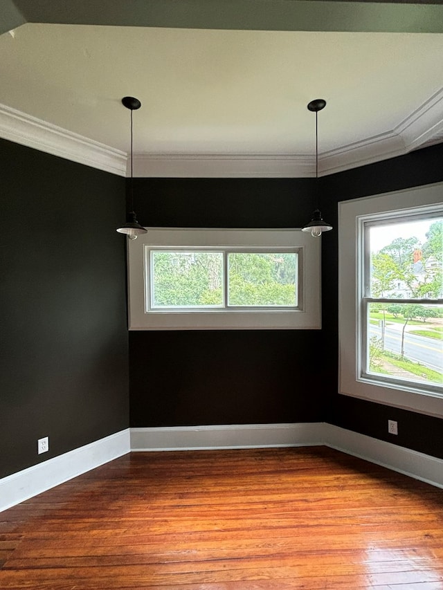 unfurnished dining area featuring light hardwood / wood-style floors and ornamental molding