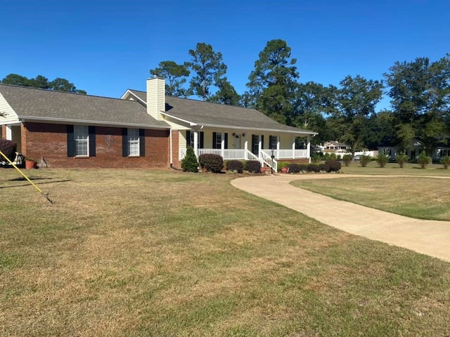 ranch-style house with covered porch and a front yard