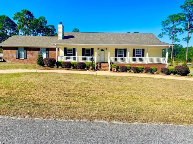 ranch-style home featuring a porch and a front yard