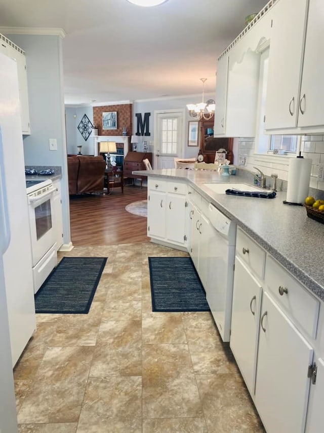 kitchen with white cabinetry, hanging light fixtures, backsplash, a chandelier, and white appliances