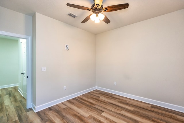 spare room with hardwood / wood-style floors and ceiling fan